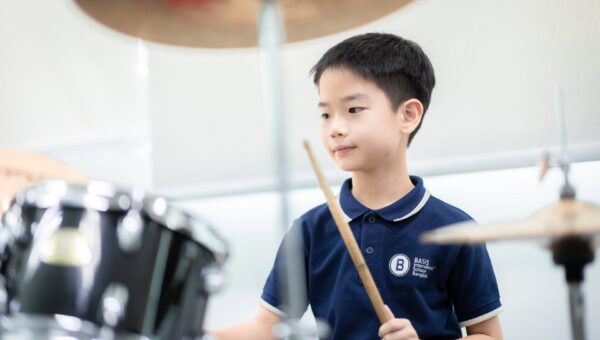 A BASIS International School Bangkok student playing the drum kit