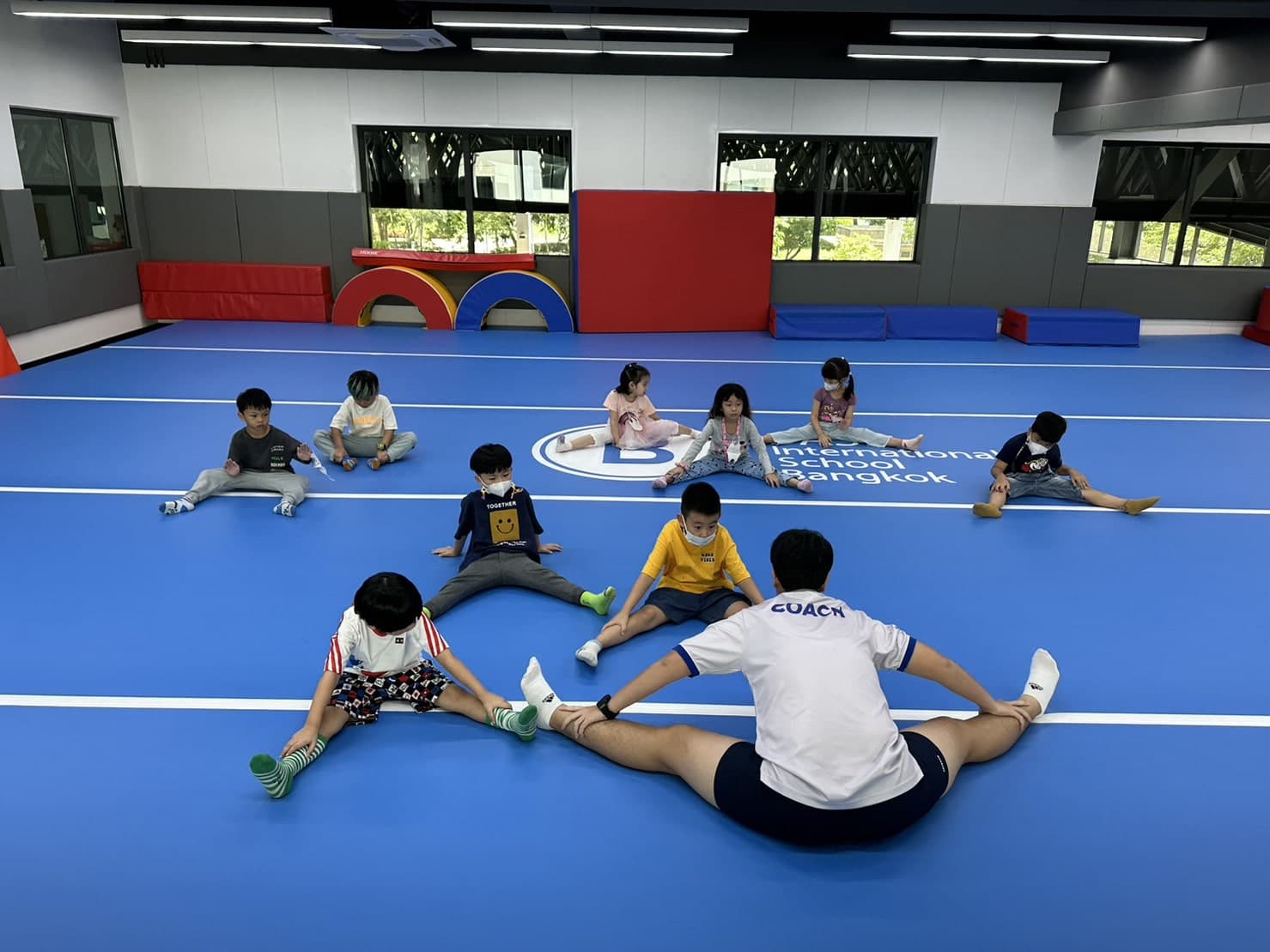 BASIS International School Bangkok students stretching during a group activity