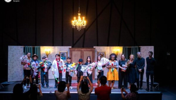The full cast of a BASIS International School Bangkok production in costume on stage