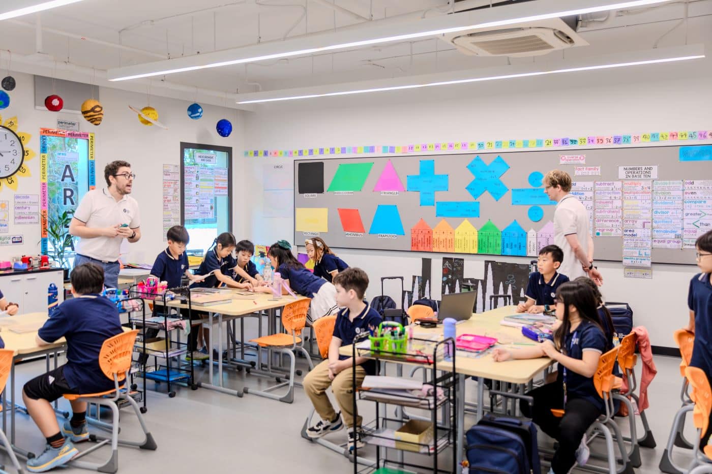 Two teachers in one classroom lead a class