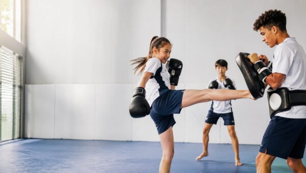 A BASIS International School Bangkok student training muay thai on pads with a coach