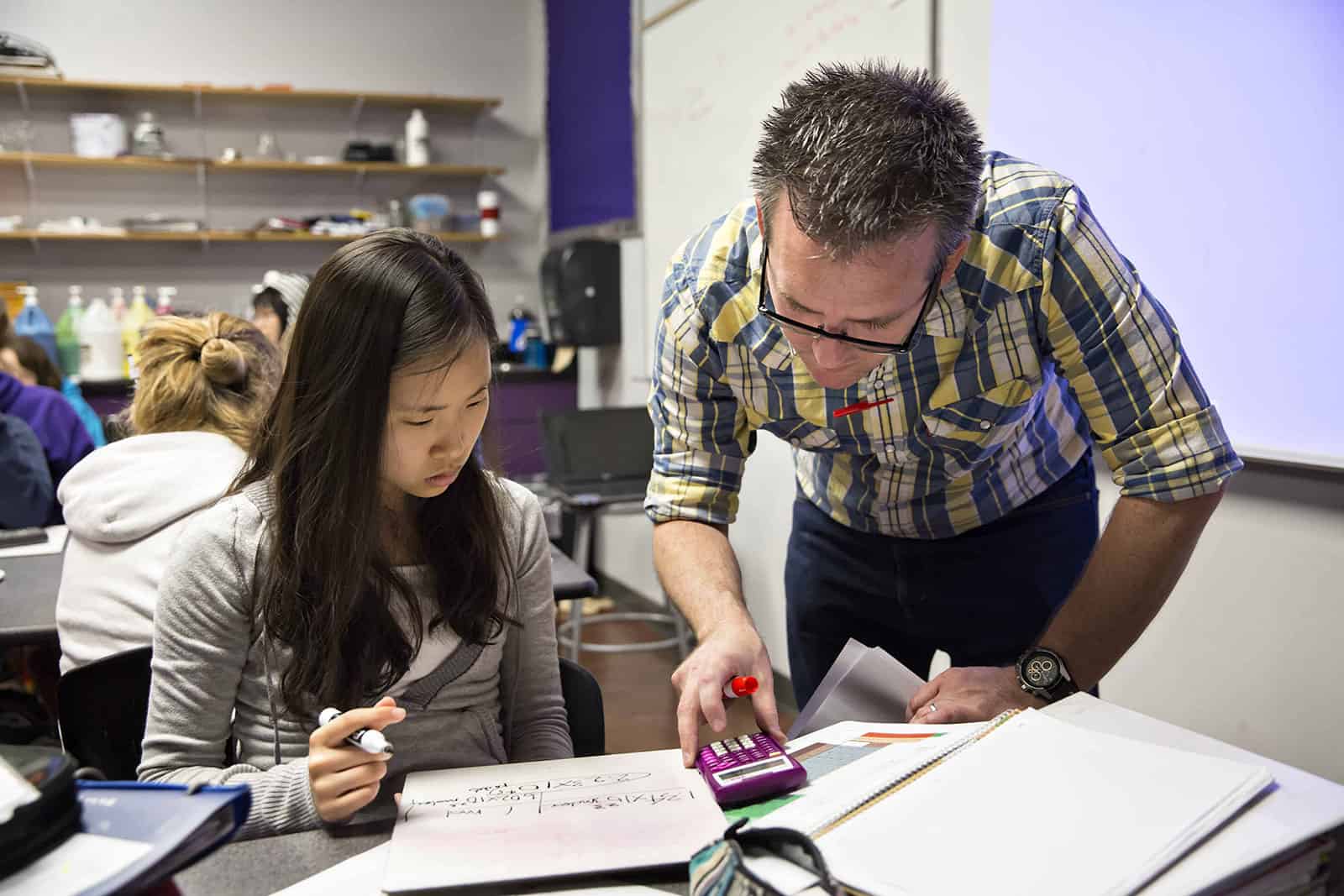 middle school-min An international middle school student receiving guidance from a teacher